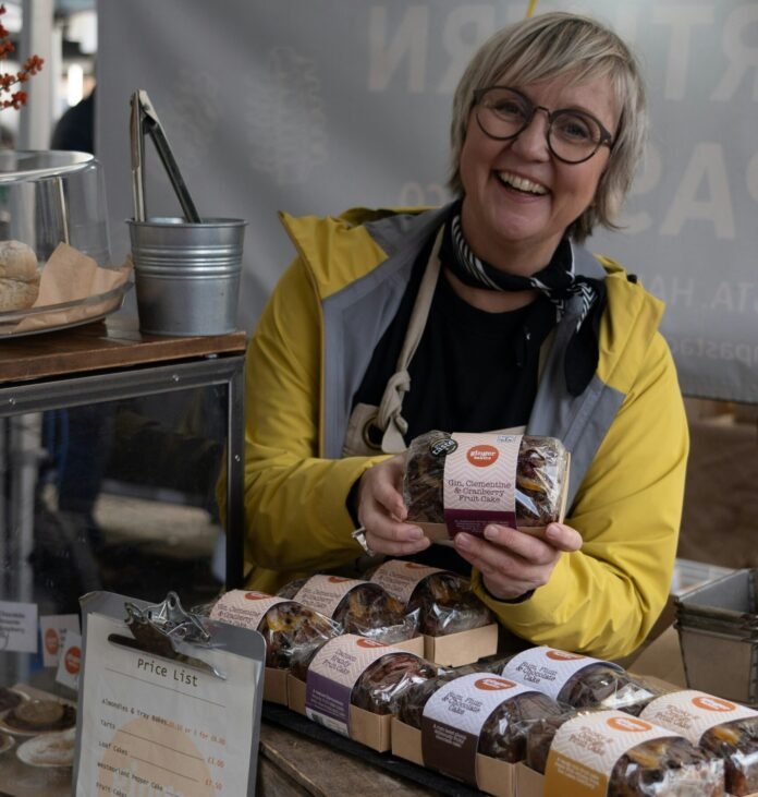 a person holding a box of cookies